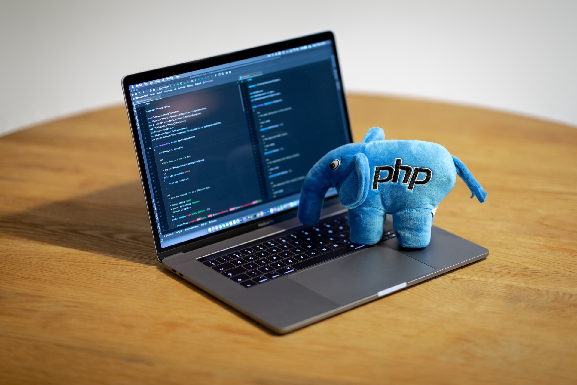 PHP elephant pretending to type on computer